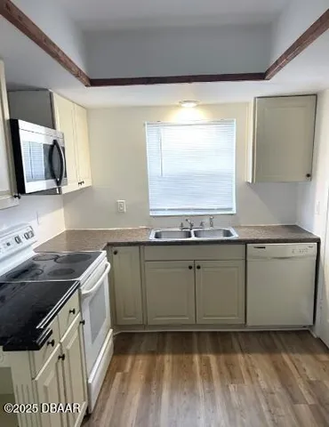 a kitchen with granite countertop a sink and a stove