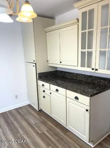 a kitchen with granite countertop white cabinets and white appliances