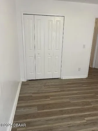 a view of a room with wooden floor