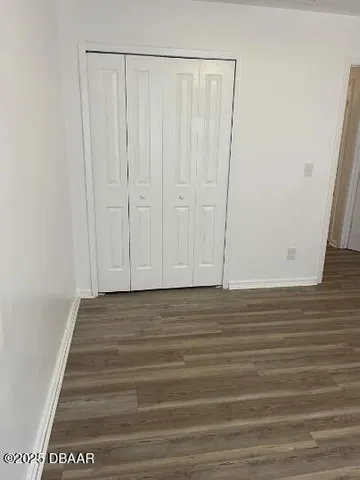 a view of a room with wooden floor