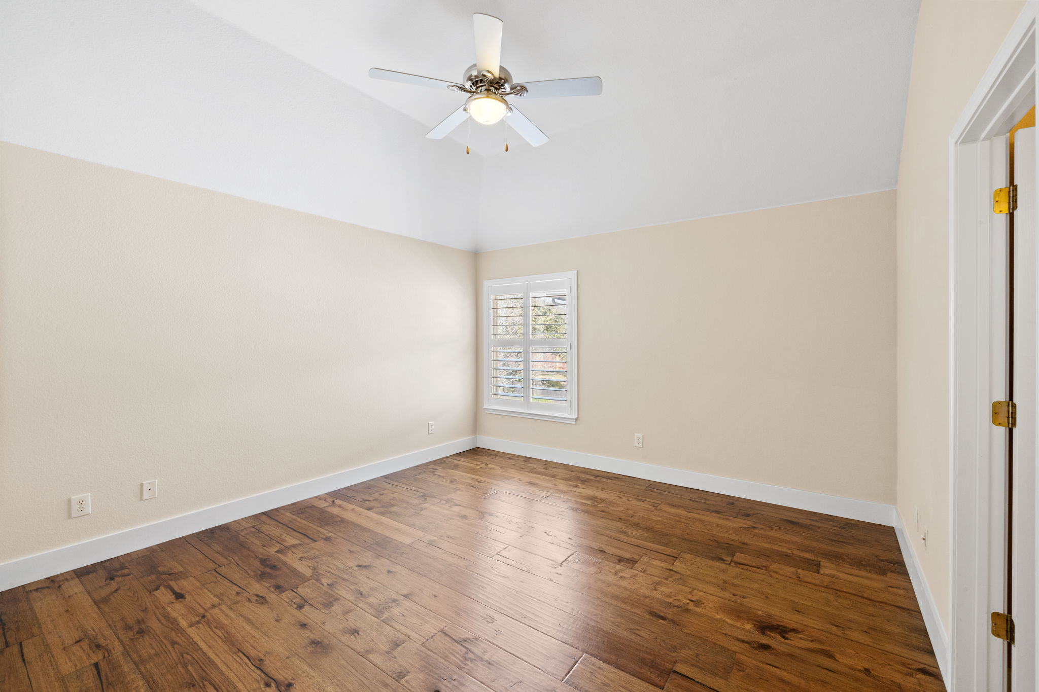 8112 Cobblestone Austin, TX 78735 - Photo 31 of 33 Empty room with a ceiling fan, hardwood / wood-style floors, and high vaulted ceiling