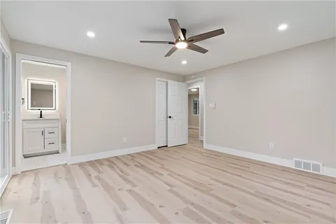a view of an empty room and wooden floor