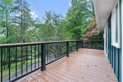 a view of balcony with wooden floor