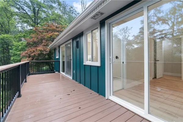 a balcony view with wooden floor and wooden fence