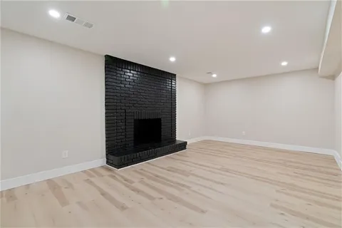 a view of an empty room with a fireplace