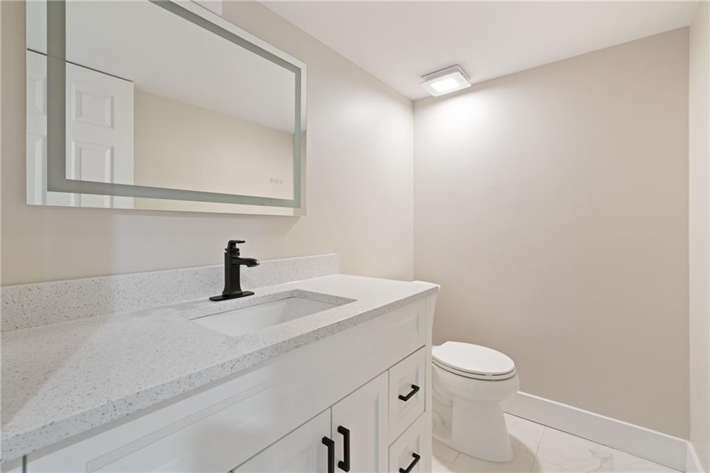 4309 Bulltown Road Murrysville, PA 15668 - Photo 25 of 34 a bathroom with a granite countertop sink toilet and mirror