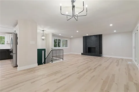 a view of a livingroom with a furniture wooden floor and window