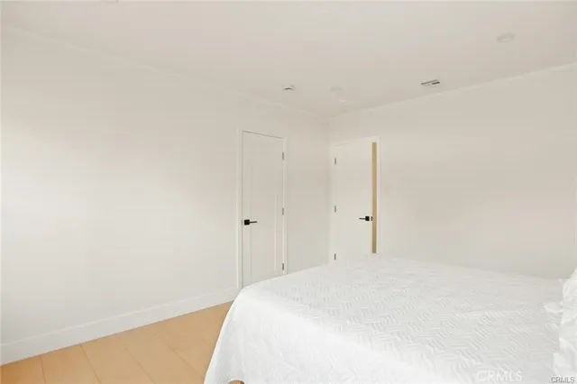 a large white bed in a white room