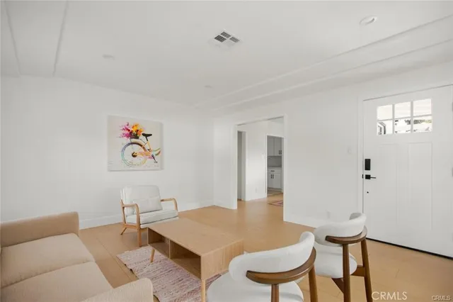 a view of a room with furniture and wooden floor