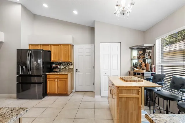 a kitchen with stainless steel appliances granite countertop a refrigerator sink and stove