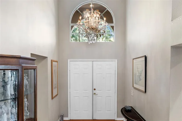 a spacious bedroom with a bed and a large window