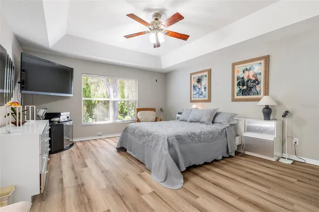 a spacious bedroom with a bed and a desk