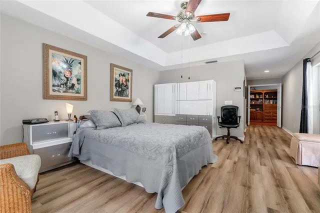 a spacious bathroom with a granite countertop sink a mirror and a bathtub