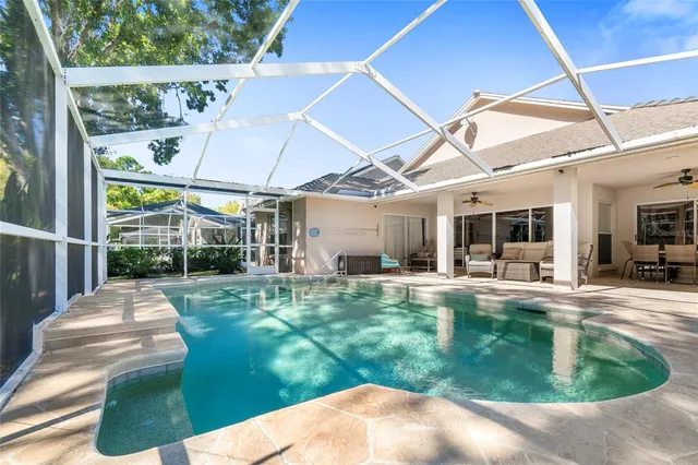 a view of a house with backyard porch and sitting area