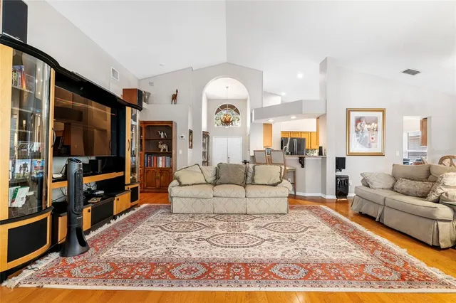 a living room with furniture a rug and a flat screen tv