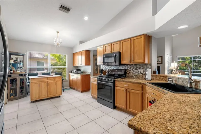 a kitchen with a sink appliances and cabinets