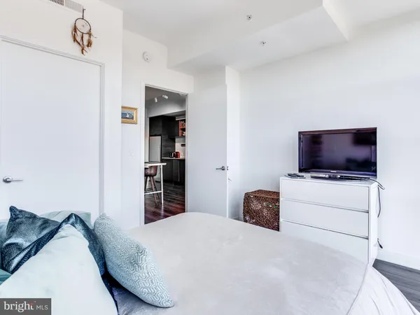 a bedroom with a bed and a television
