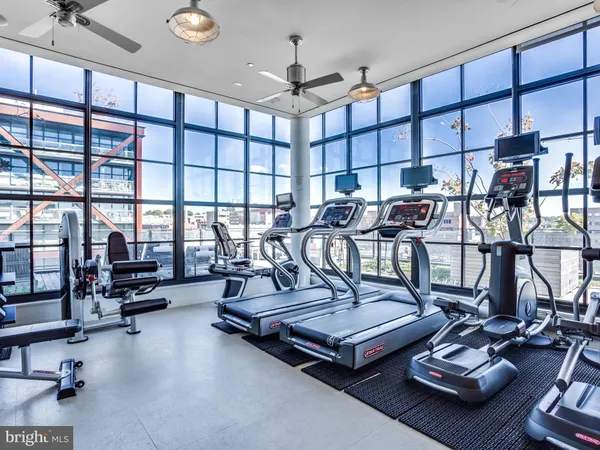 a living room with furniture gym equipment and a view of living room