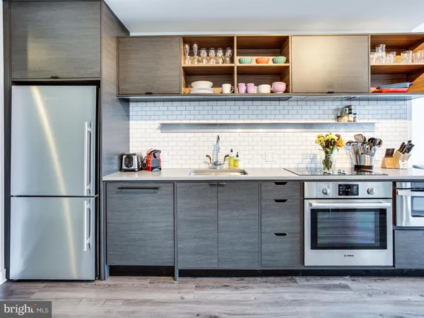 a kitchen with stainless steel appliances granite countertop a refrigerator and a sink