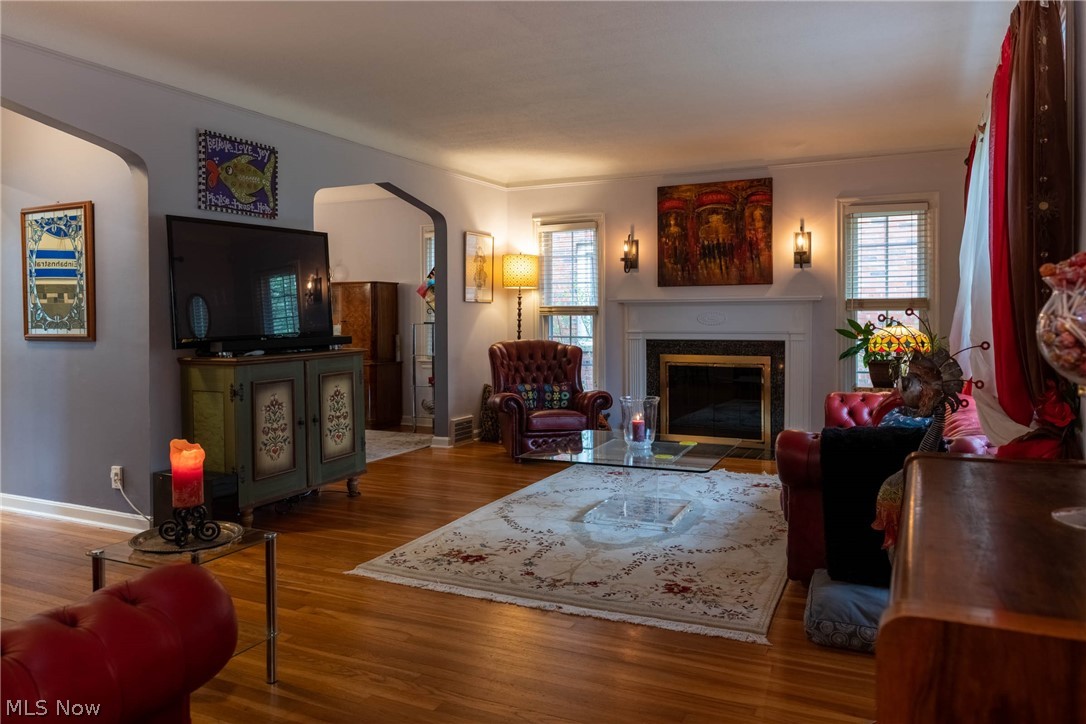 3433 Bradford Road Cleveland, OH 44118 - Photo 13 of 35 This comfortable & large Living rm is accented by gleaming Hrd Wd Flrs & newer side windows w/ Plantation Blinds. The wall sconces above the mantel, accent the decorative Wd burning FP trimmed in black marble.