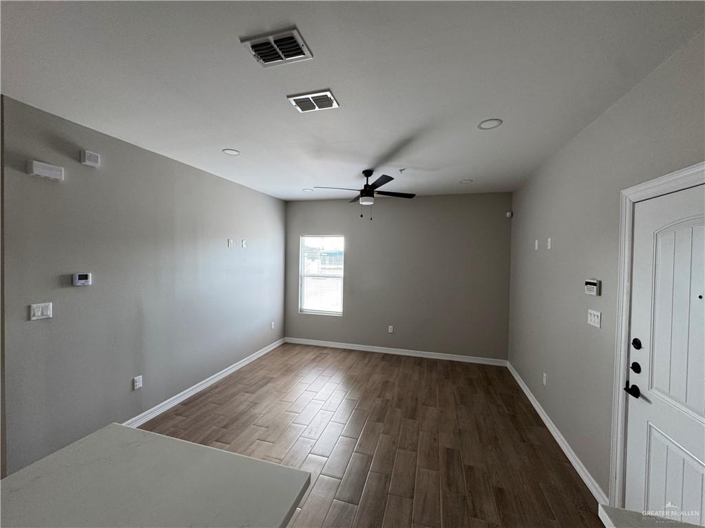 800 Ragland Road, Unit 2 Mission, TX 78572 - Photo 3 of 10 an empty room with wooden floor and windows