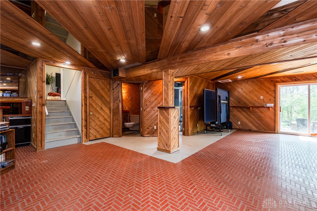 728 Chipplegate Drive Centerville, OH 45459 - Photo 23 of 30 This versatile basement space features natural wood paneling and a unique brick flooring pattern.