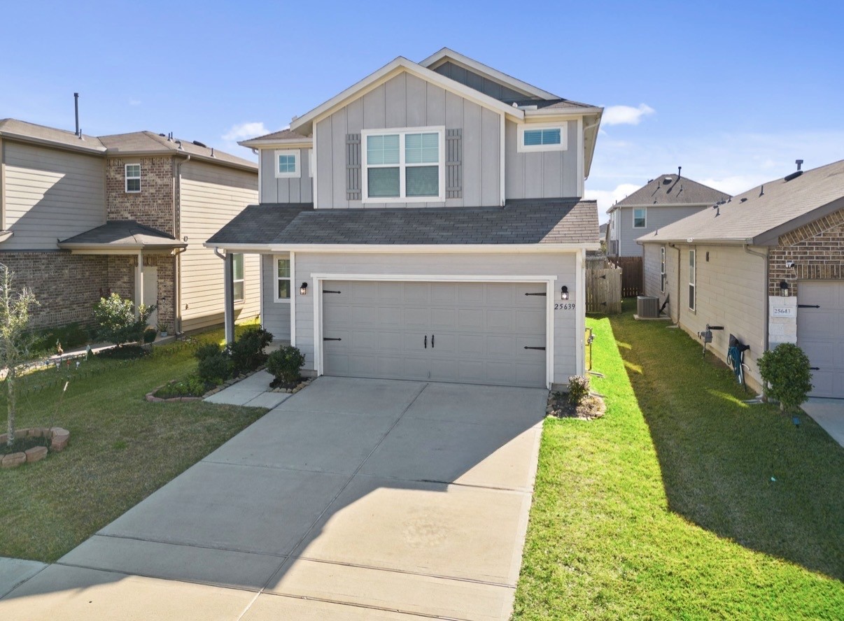 a front view of a house with a yard and garage