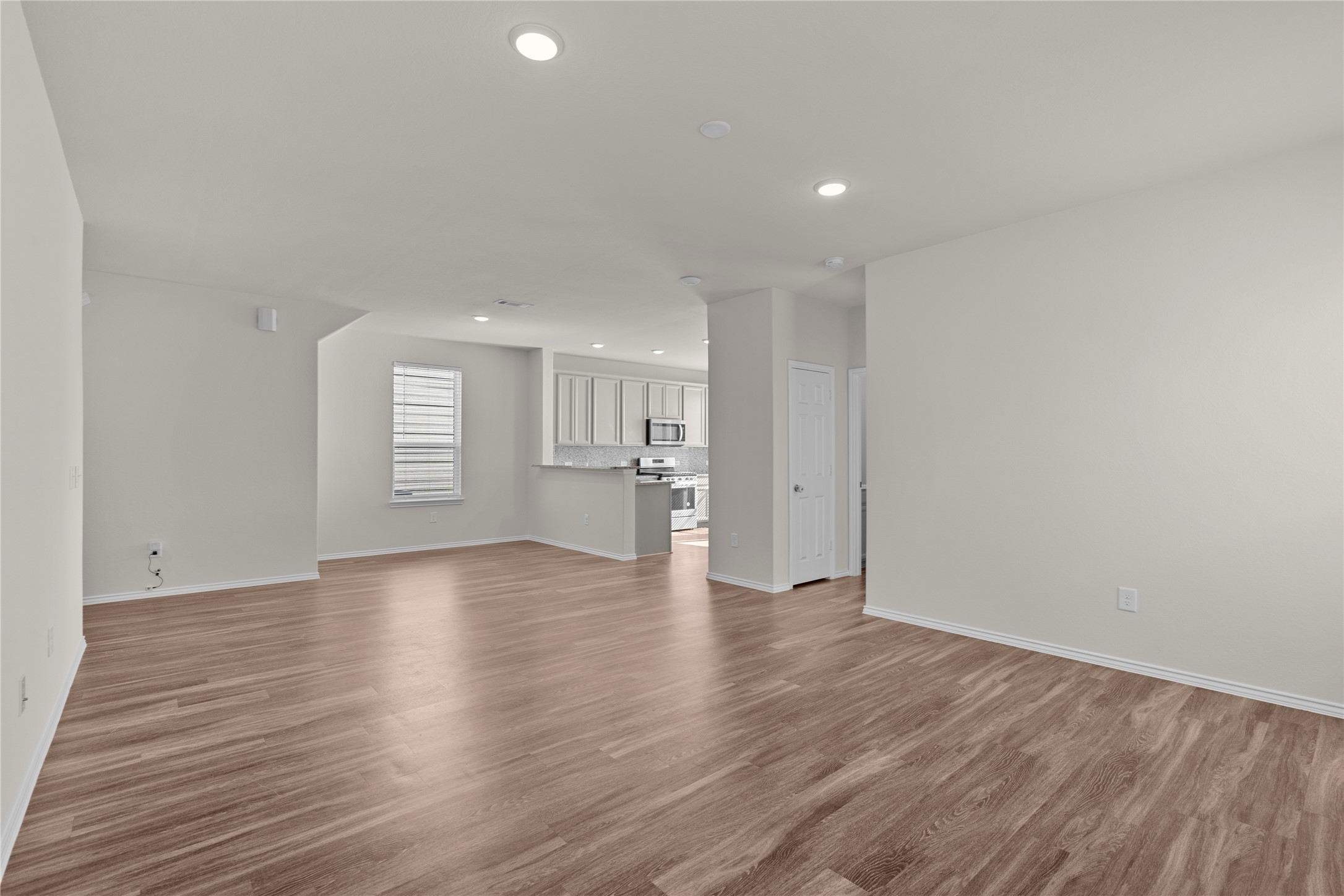 25639 Royal Catchfly Road Katy, TX 77493 - Photo 11 of 48 a view of an empty room with wooden floor and windows