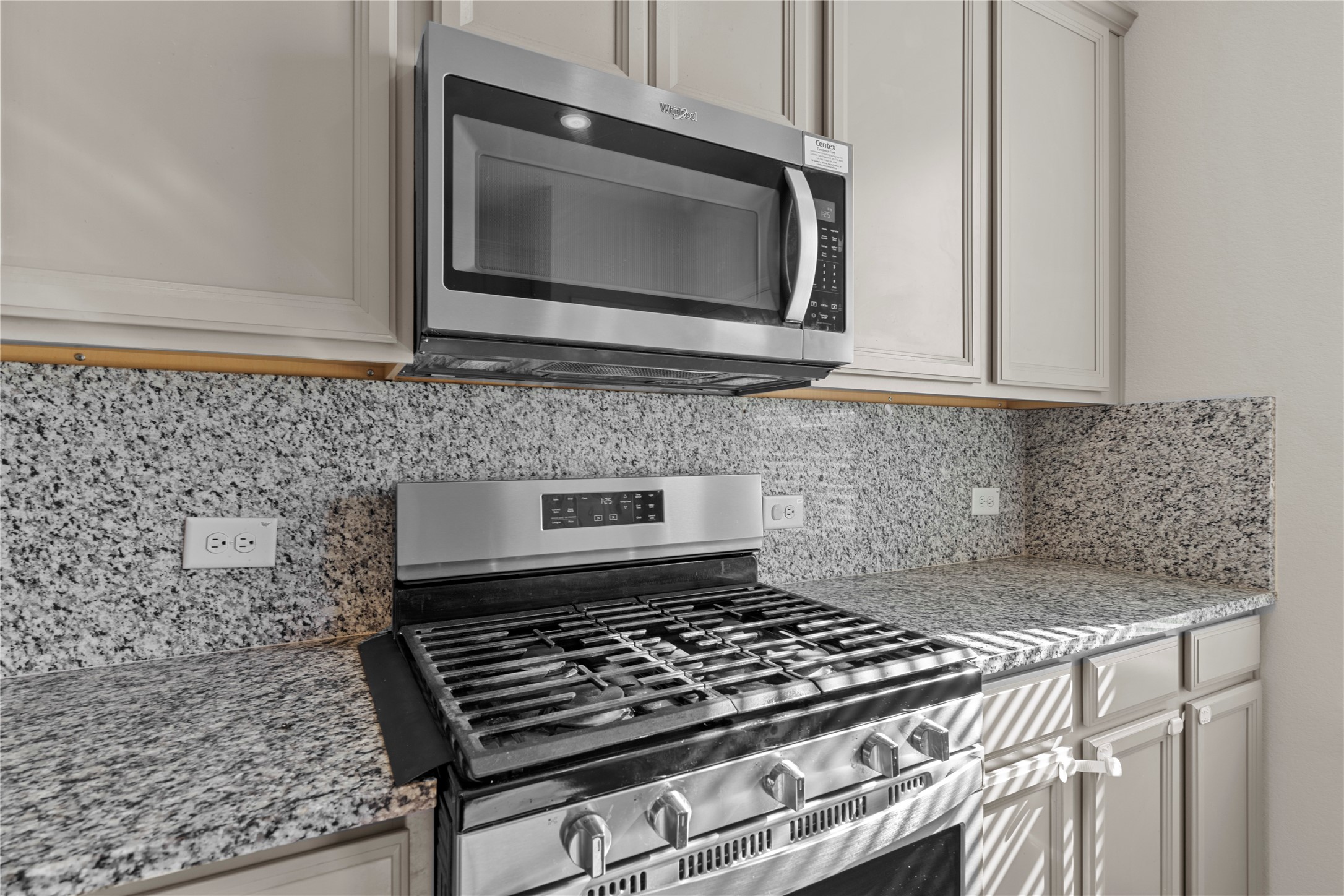 25639 Royal Catchfly Road Katy, TX 77493 - Photo 15 of 48 a kitchen with granite countertop a stove and a microwave