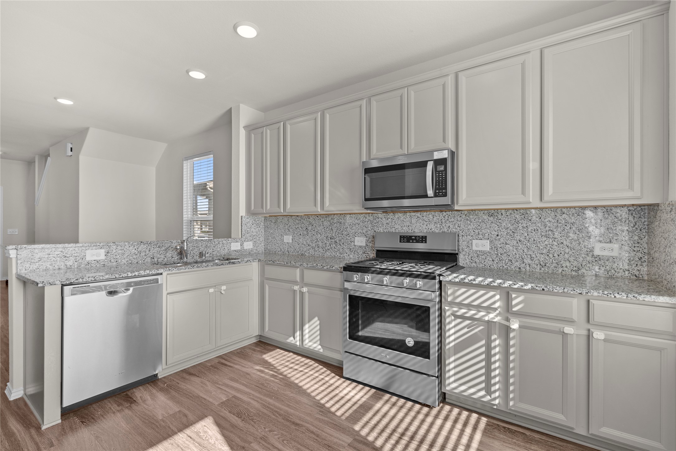 25639 Royal Catchfly Road Katy, TX 77493 - Photo 16 of 48 a kitchen with stainless steel appliances granite countertop a stove a sink and a microwave