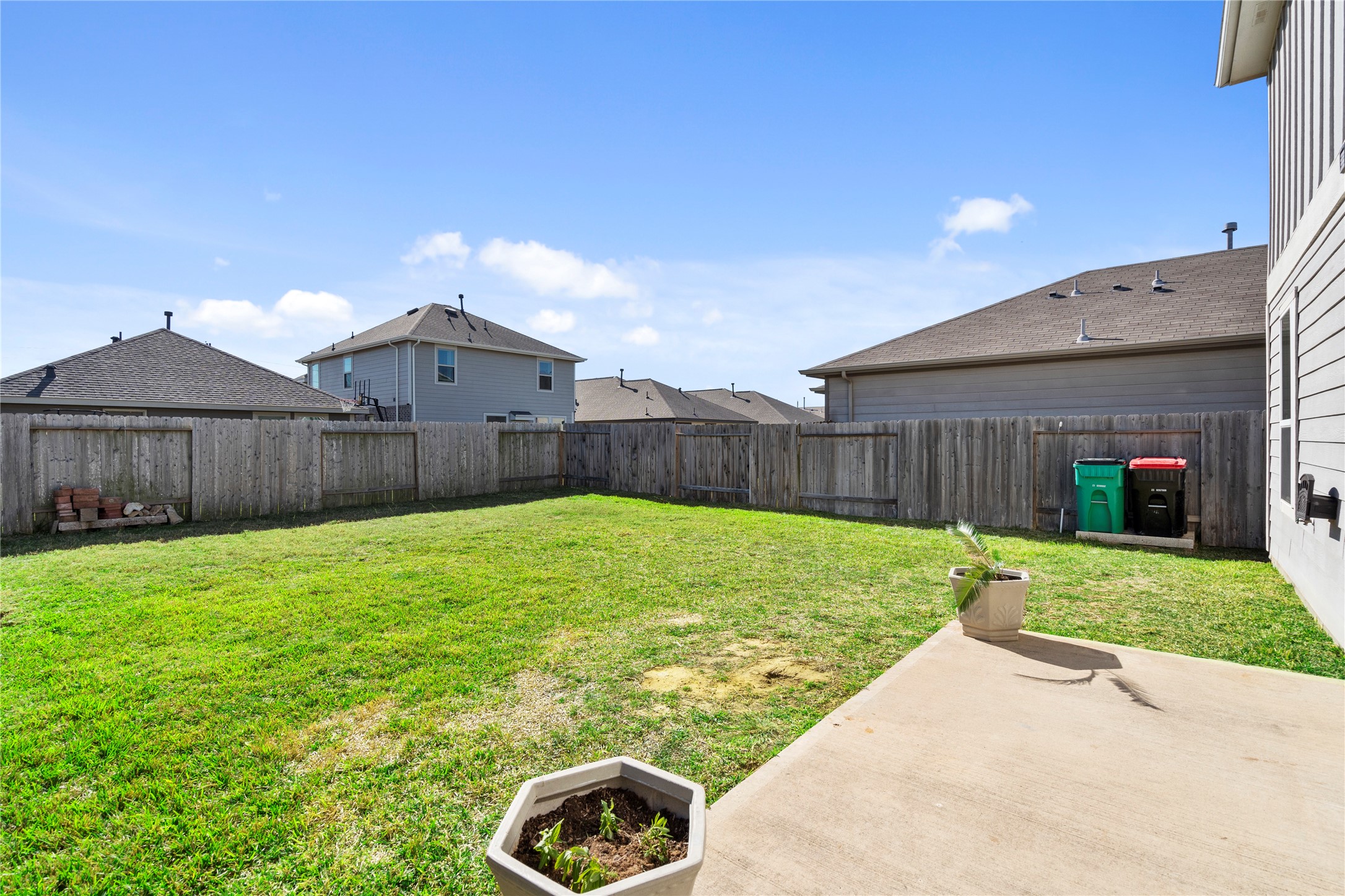 25639 Royal Catchfly Road Katy, TX 77493 - Photo 44 of 48 a view of a backyard with table and chairs a barbeque and wooden fence