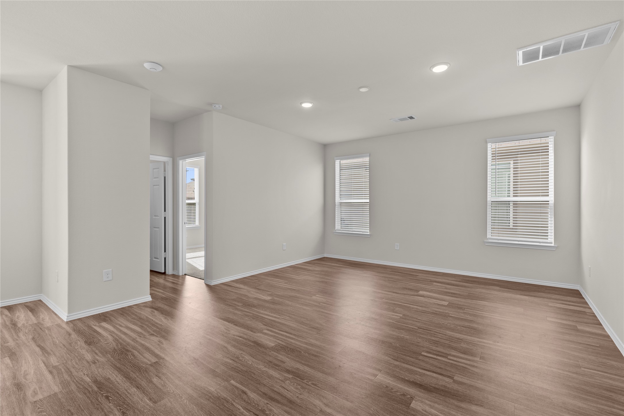 25639 Royal Catchfly Road Katy, TX 77493 - Photo 7 of 48 a view of an empty room with wooden floor and windows
