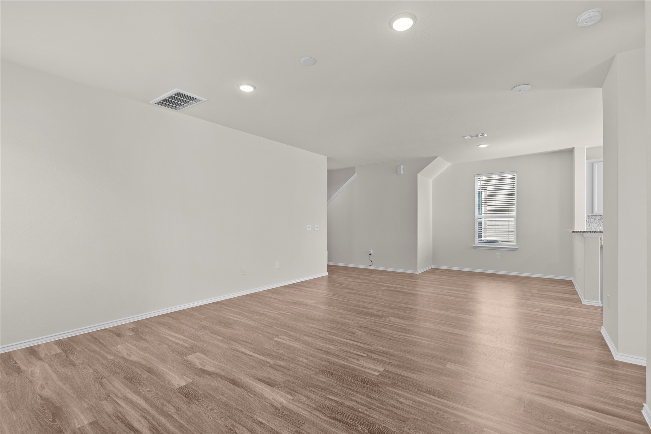 25639 Royal Catchfly Road Katy, TX 77493 - Photo 9 of 48 a view of an empty room with wooden floor and a window