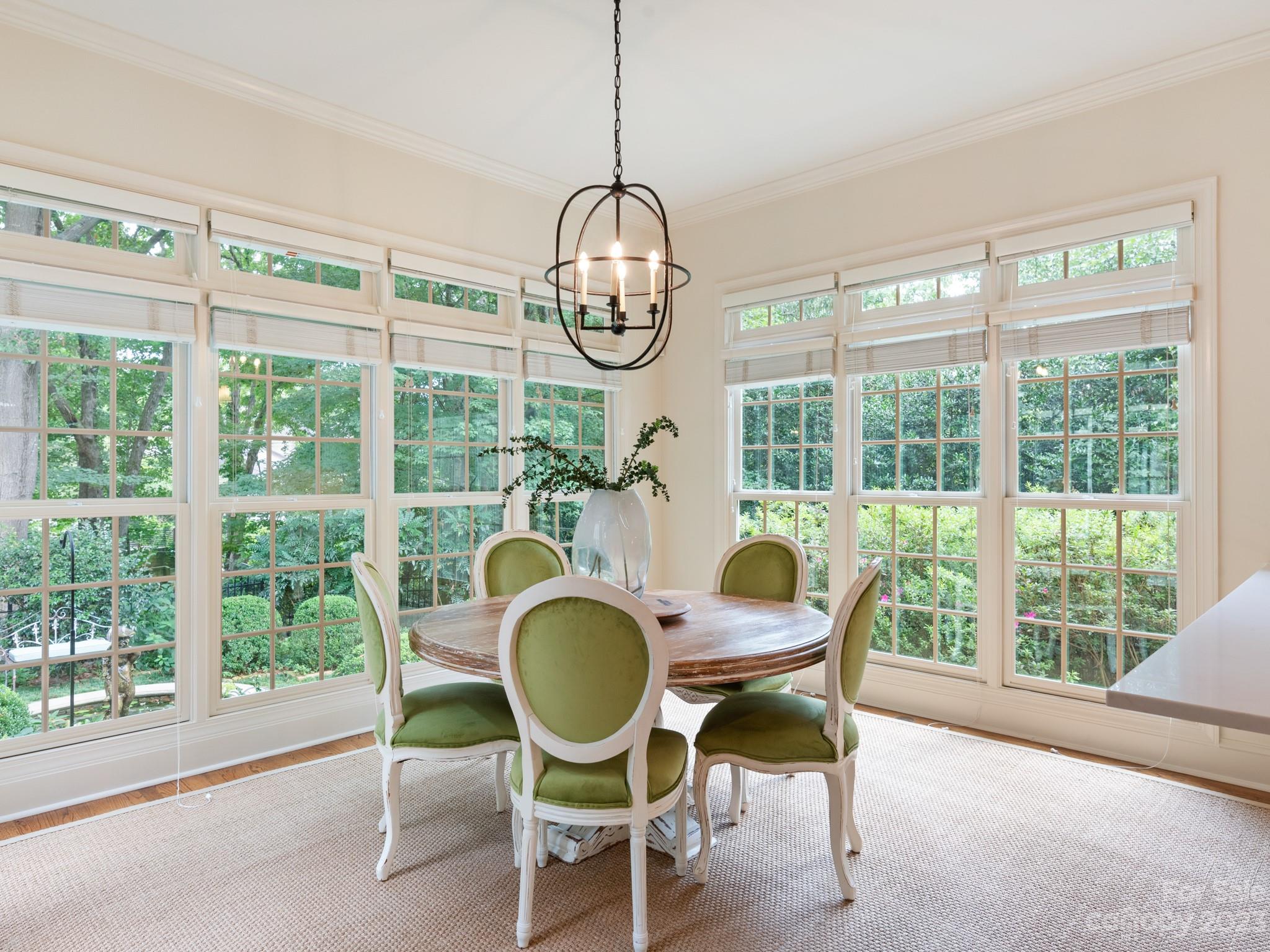 2521 Summerlake Road Charlotte, NC 28226 - Photo 20 of 48 a dining room with furniture a chandelier and wooden floor