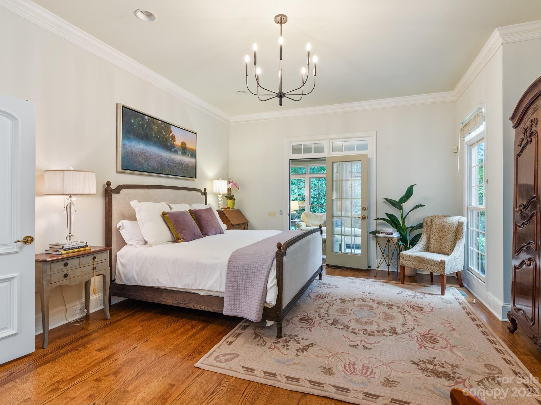 2521 Summerlake Road Charlotte, NC 28226 - Photo 26 of 48 a bedroom with a large bed and a chandelier