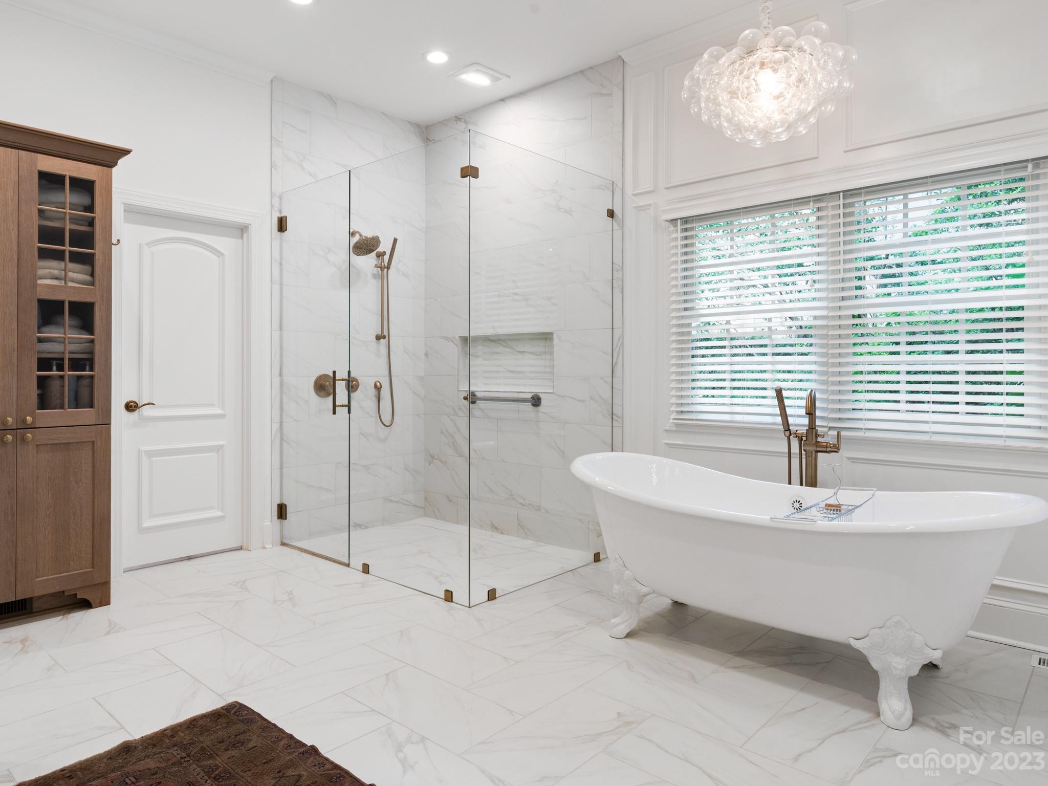 2521 Summerlake Road Charlotte, NC 28226 - Photo 28 of 48 a bathroom with a bathtub and a shower