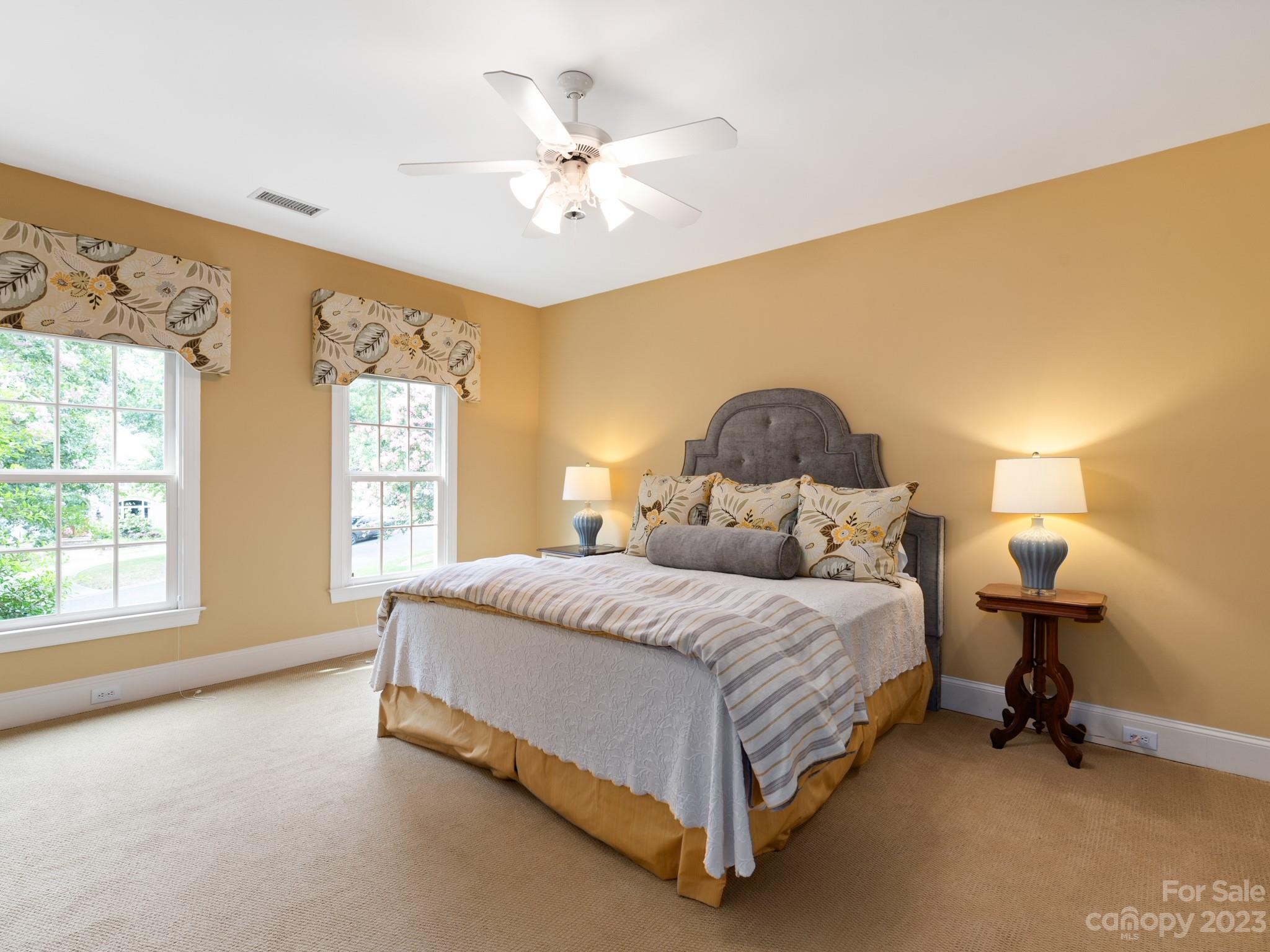 2521 Summerlake Road Charlotte, NC 28226 - Photo 37 of 48 a spacious bedroom with a bed and a chandelier