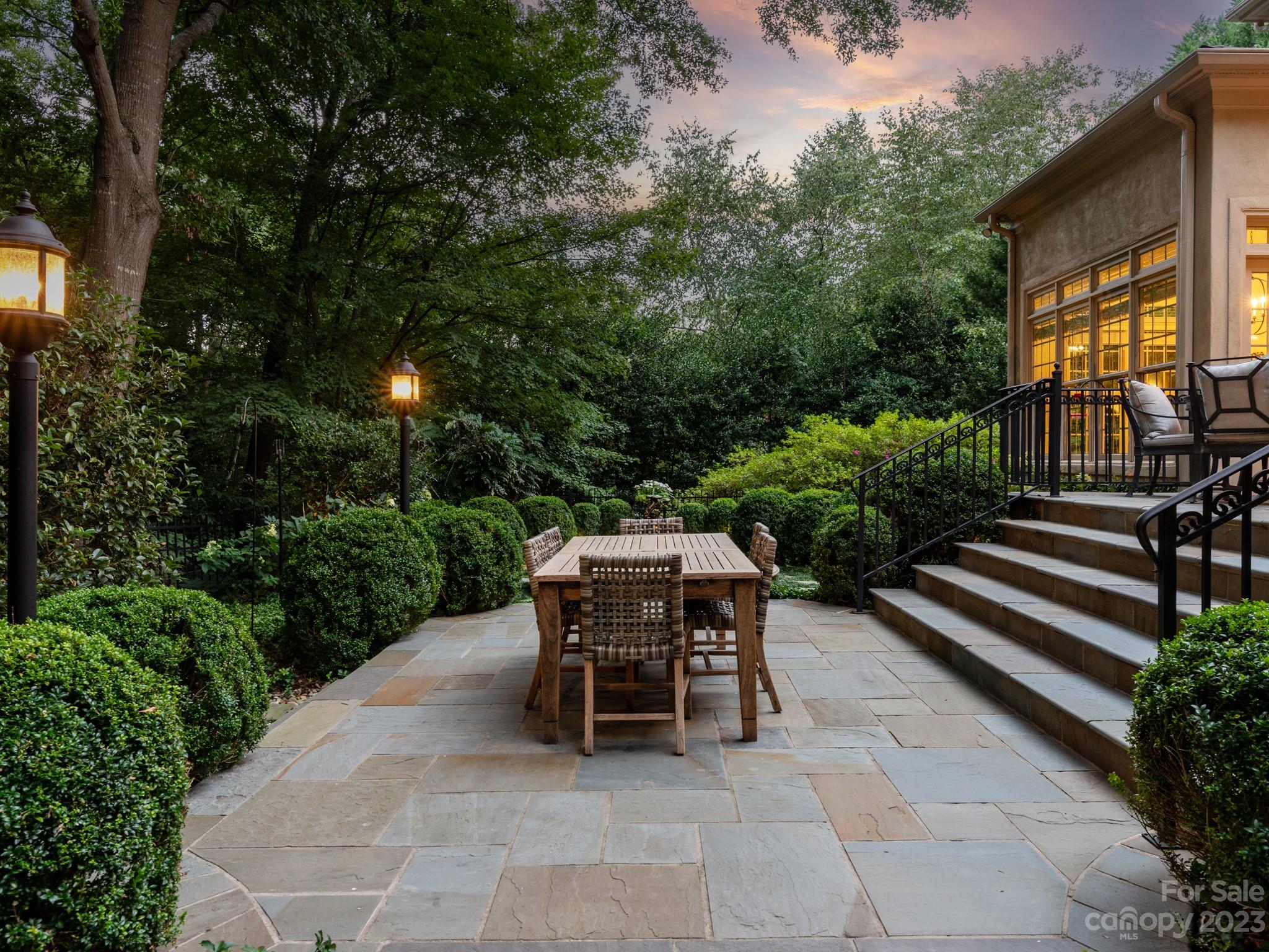 2521 Summerlake Road Charlotte, NC 28226 - Photo 8 of 48 a view of a patio with table and chairs potted plants and large tree