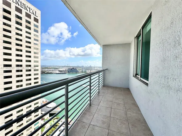 a balcony with a book table and chairs