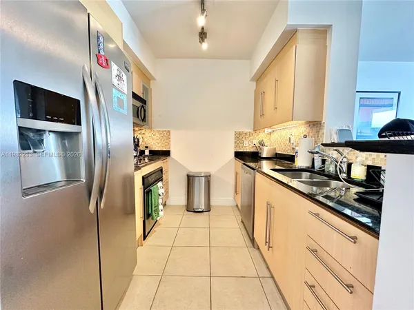 a kitchen with stainless steel appliances granite countertop a sink and cabinets