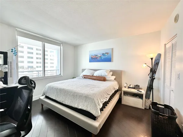 a bed room with a bed and a chair