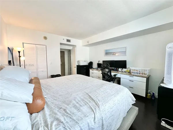 a large white bed in a white room
