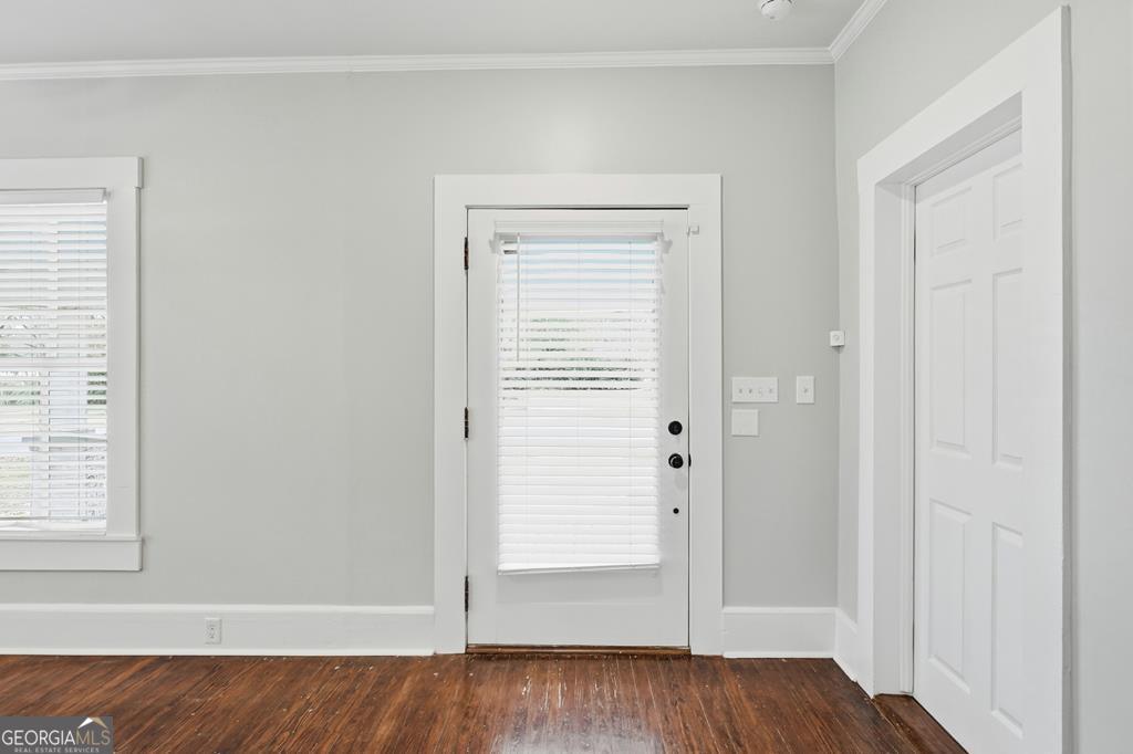 611 West 3rd Street Ocilla, GA 31774 - Photo 13 of 53 an empty room with wooden floor closet and windows
