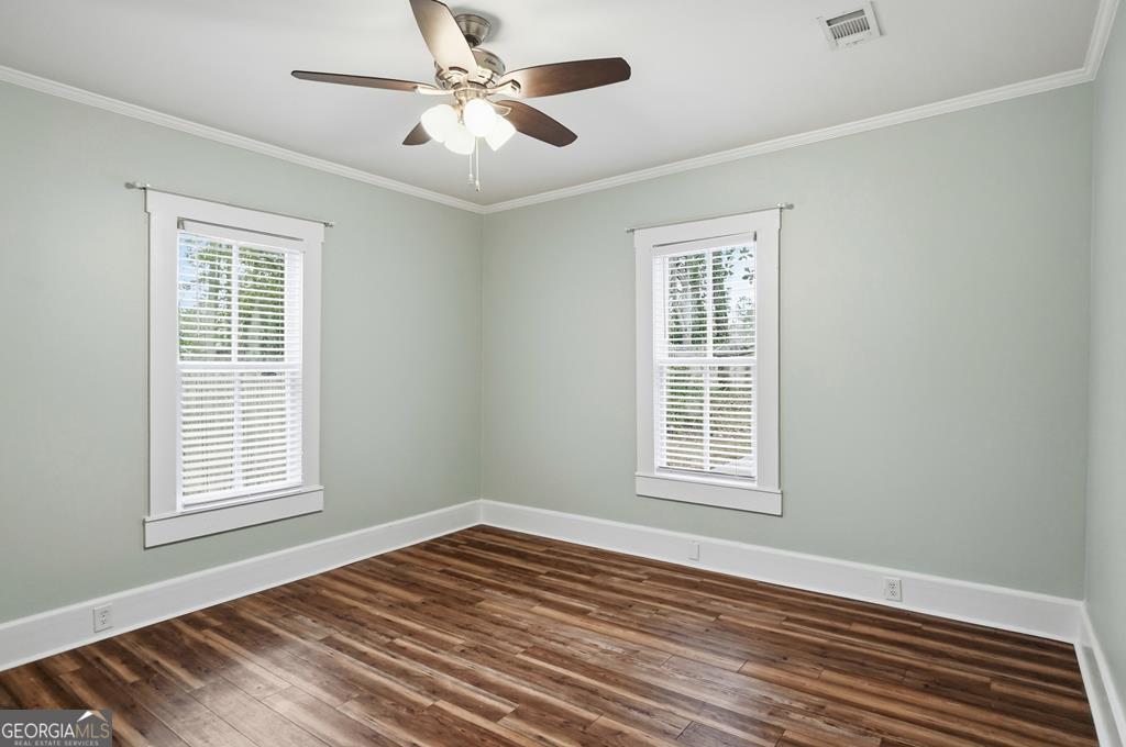 611 West 3rd Street Ocilla, GA 31774 - Photo 25 of 53 a view of an empty room with wooden floor and a window