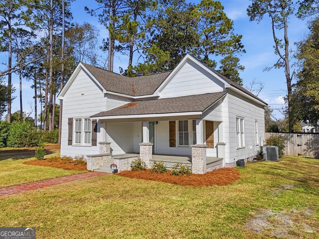 611 West 3rd Street Ocilla, GA 31774 - Photo 3 of 53 a front view of house with yard and trees around