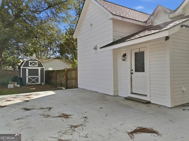a view of a house with pool and chairs