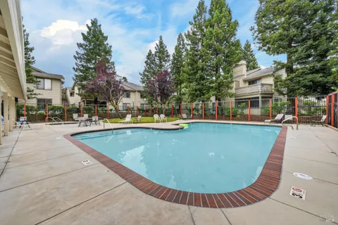a view of a swimming pool with outdoor seating