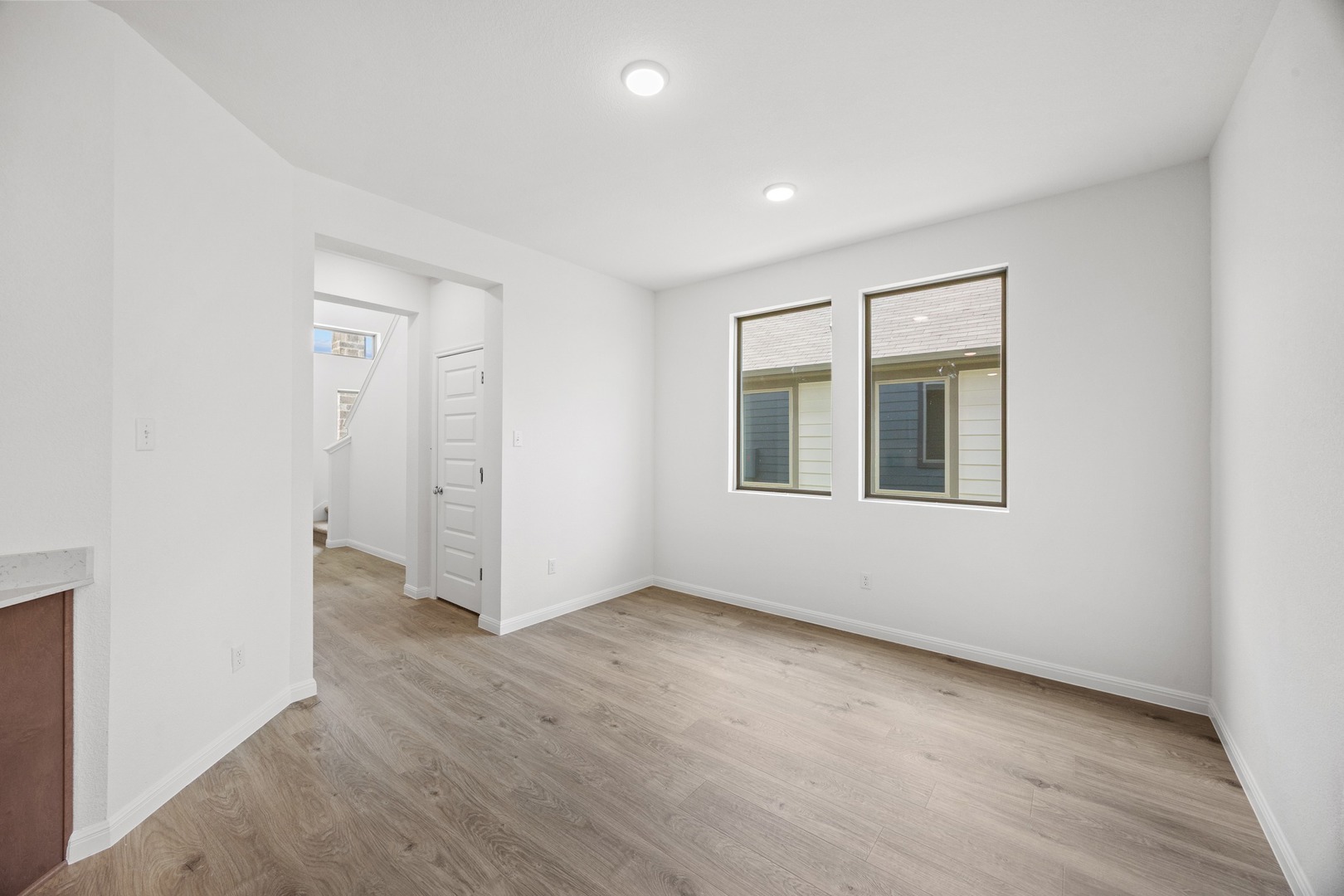 200 Hornet Street Elgin, TX 78621 - Photo 5 of 39 an empty room with wooden floor and windows