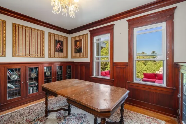 a view of a dining room with a table and chairs
