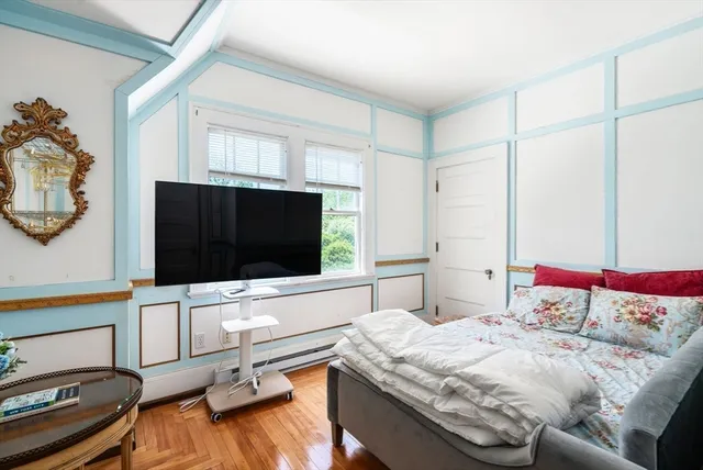 a bedroom with a bed and a flat screen tv